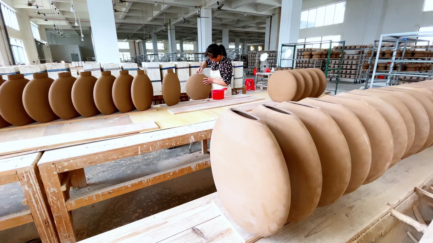 Row of freshly cast vases drying